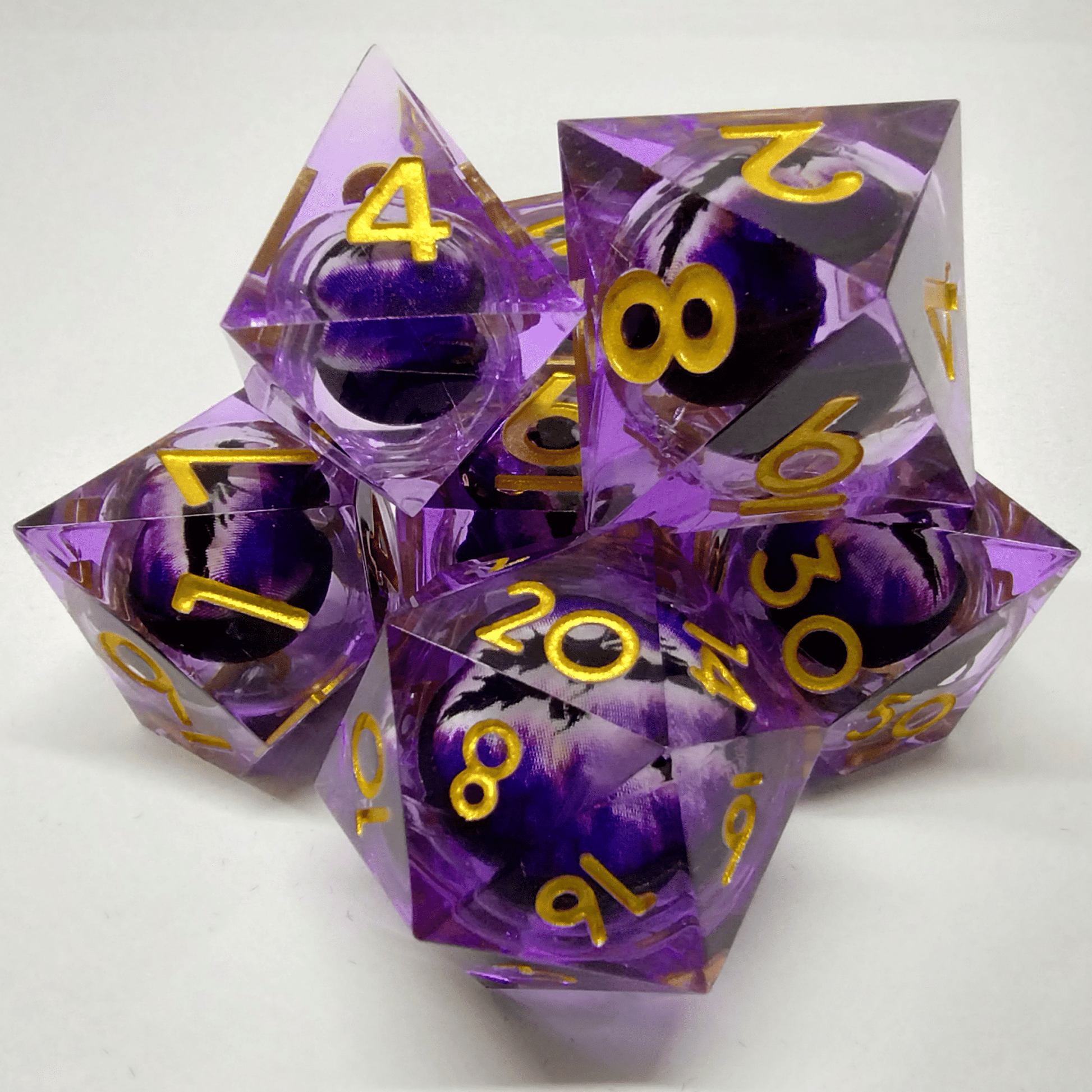 Liquid Core Purple and Black Dragon Eye Sharp Edge 7 Piece Dice Set image 0
